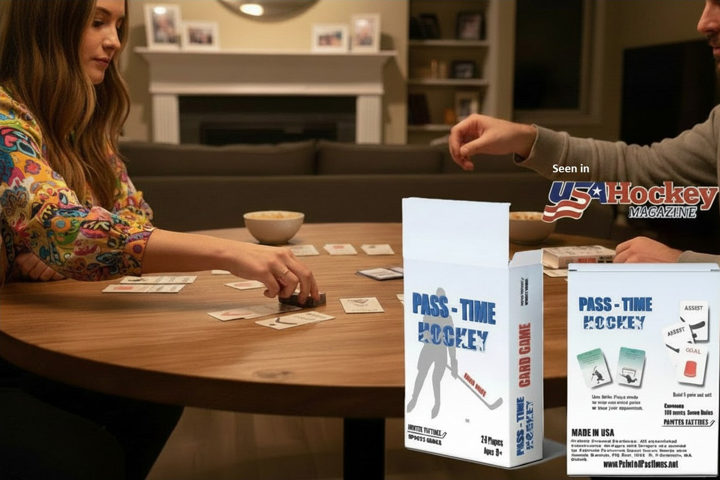 Two people sitting at a wooden table playing a card game with cards spread on the table. In the foreground, two product boxes for 'Pass-Time Hockey' are shown, with one white box featuring blue text and graphics, and another white box showing included accessories.