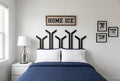 Ten black hockey sticks are strategically placed to create a stunning headboard look to this bedroom with lots of hockey decor.