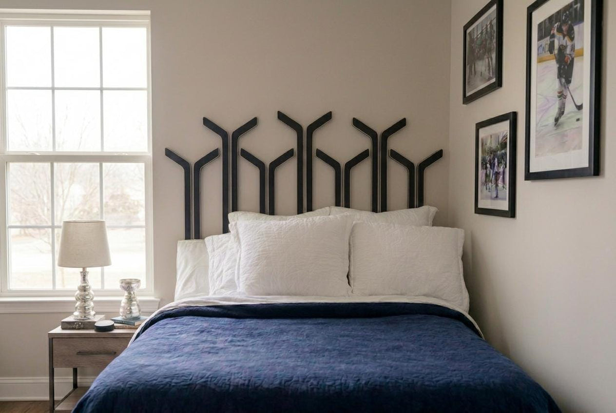 Fourteen black hockey sticks are strategically placed to create a stunning headboard look to this bedroom with lots of hockey decor.