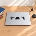 A decal of two mice playing hockey and shooting the puck at a mouse hole instead of a net.  This is placed on the the cover of a laptop and it sitting on a desk in a kid's bedroom.  It's a very light and airy bedroom with hockey decor.