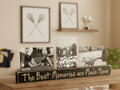 A wooden sports memorabilia display stand with the engraved phrase 'The Best Memories are Made Here' holding three black-and-white lacrosse photos, set on a wooden shelf in a warm indoor room.