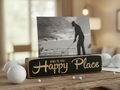 A rectangular wooden photo plaque stand with the phrase 'this is my Happy Place' in lasered lettering on a dark wood front. The stand holds a black-and-white golf-themed photo of a golfer silhouette.
